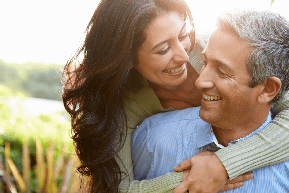 woman over the shoulders of a man outside after receiving peptide therapy