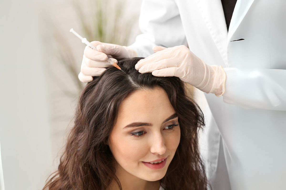 Exosome hair therapy performed on a man lying down during a non-invasive scalp treatment session.