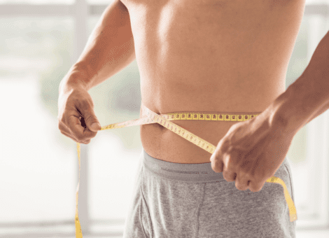 Man measuring his waist after Semaglutide weight loss