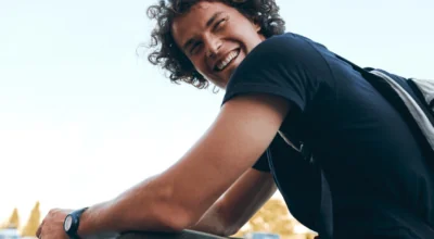 Young man with vibrant energy and smile, possibly benefiting from hormone therapy.