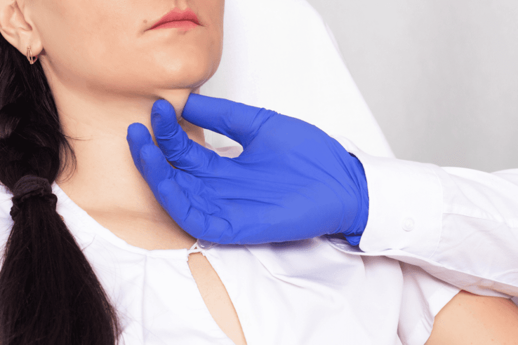Consultation before a chemical peel for hyperpigmentation with a gloved professional examining the neck.