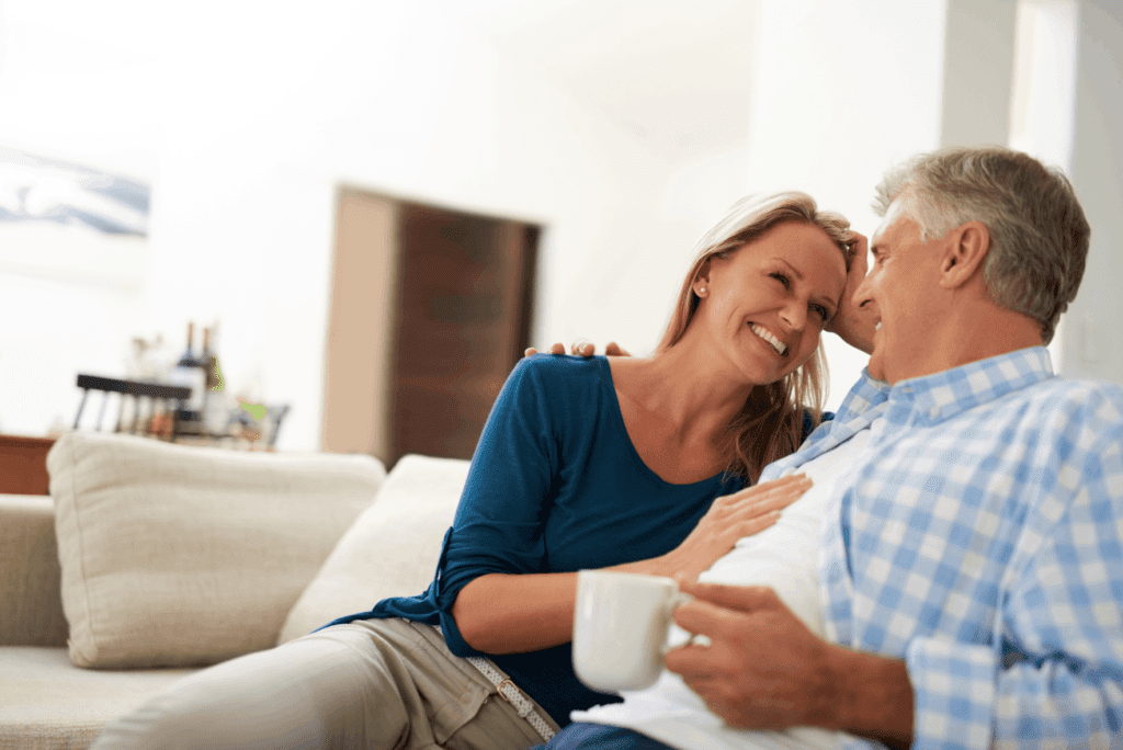 Middle-aged couple enjoying closeness at home, possibly after starting pellets for hormones.