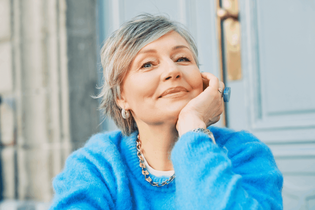 Smiling older woman with firm skin, representing results of non-invasive skin tightening.