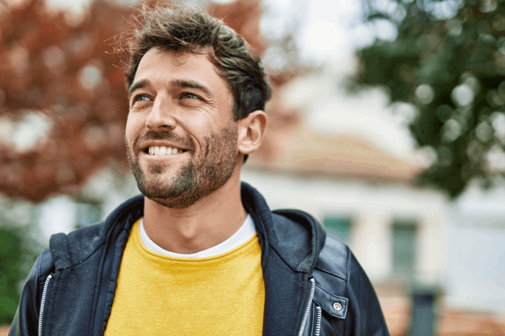 TRT for men results shown by a smiling man with renewed energy and confidence outdoors.