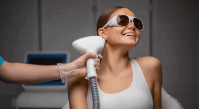 Skin resurfacing treatments using laser technology on a smiling woman wearing protective eyewear.