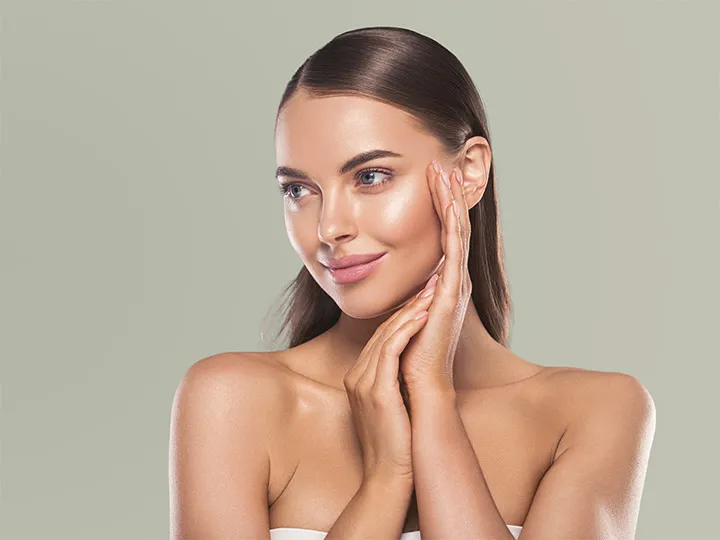 Woman with smooth skin touching her cheek